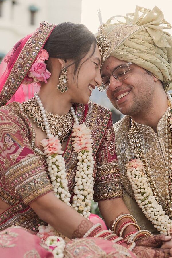 Indian bride and groom laughing together