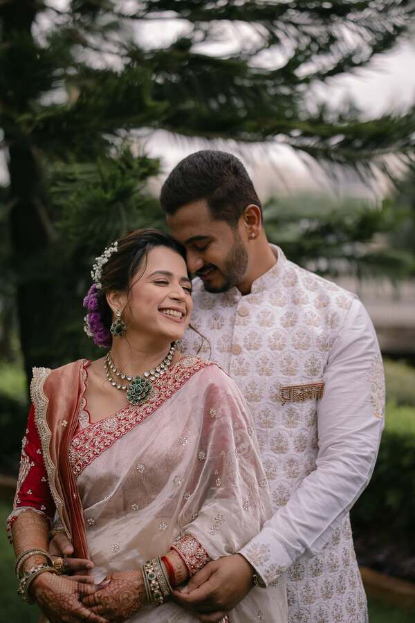 Indian couple in pastel engagement clothes